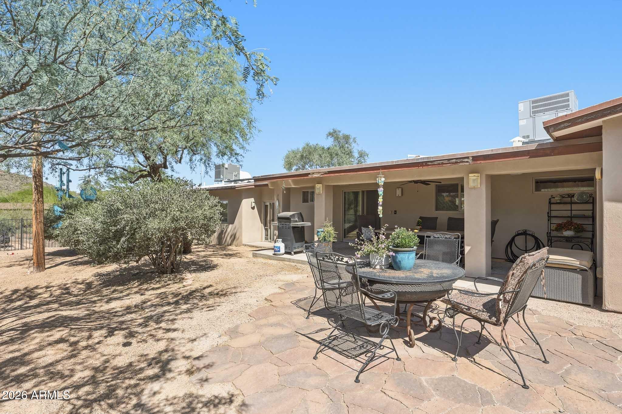 6019 East Blue Ridge Drive Cave Creek, AZ 85331 - Photo 49 of 49 a view of a house with backyard sitting area and garden