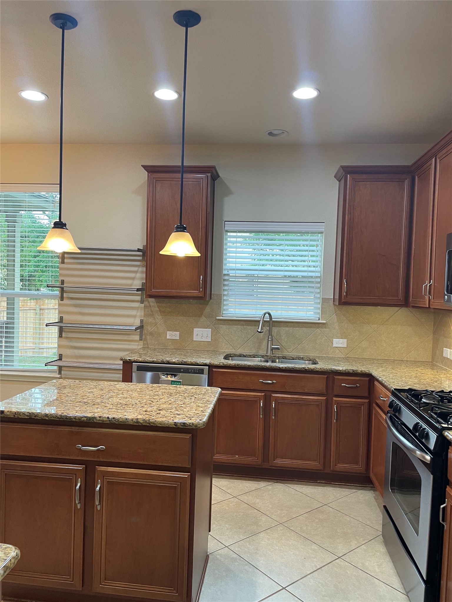 102 Sandy Lyle Cove Round Rock, TX 78664 - Photo 11 of 38 a kitchen with a sink stove and cabinets