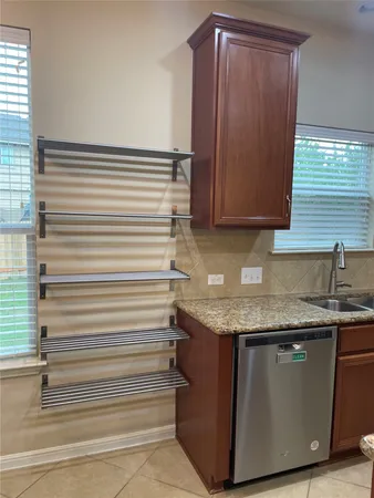a kitchen with granite countertop sink and cabinets
