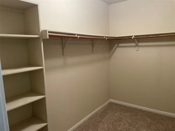 a white toilet sitting next to a shower