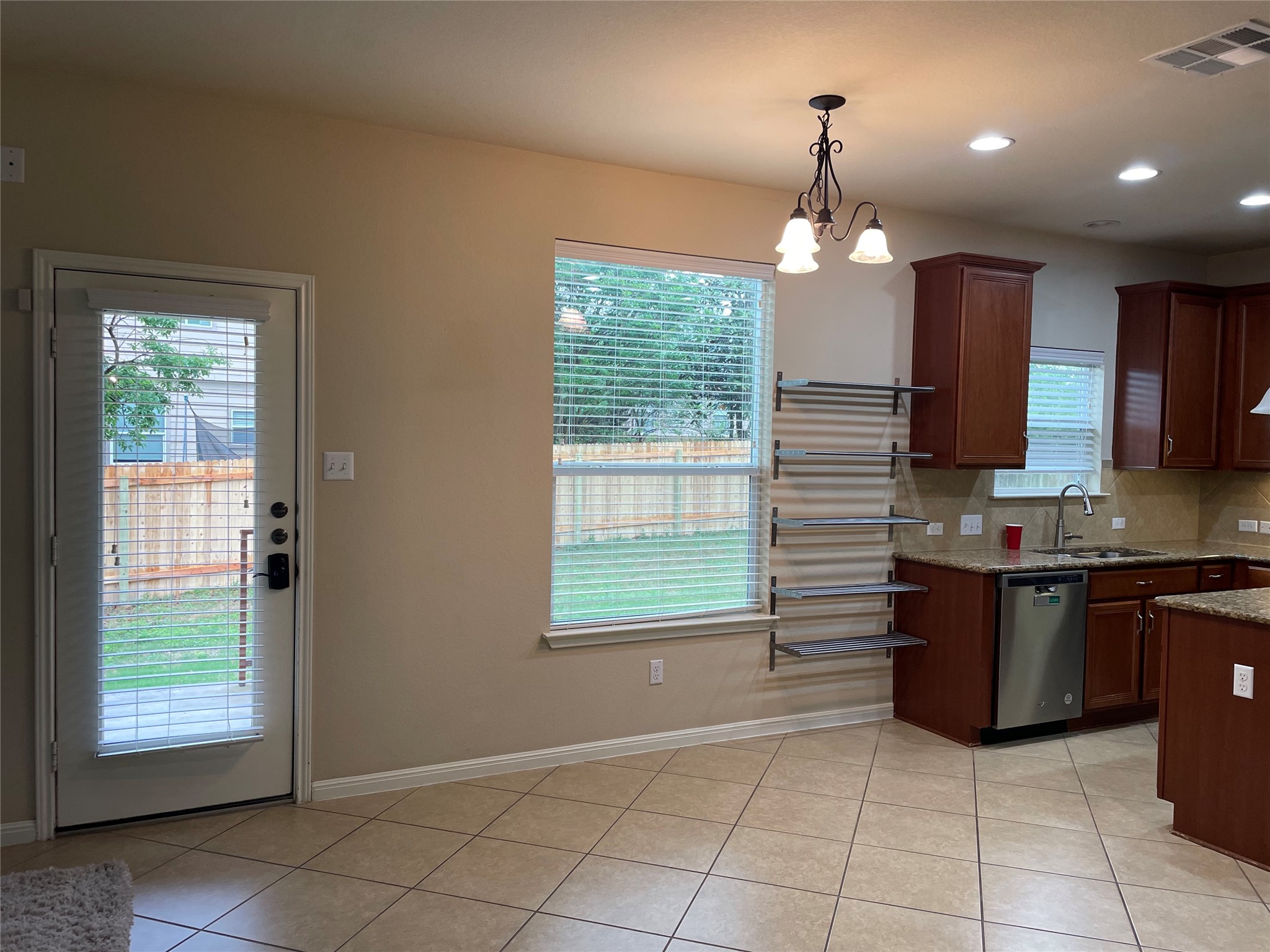 102 Sandy Lyle Cove Round Rock, TX 78664 - Photo 9 of 38 a kitchen with stainless steel appliances granite countertop a refrigerator a sink a stove top oven and a window