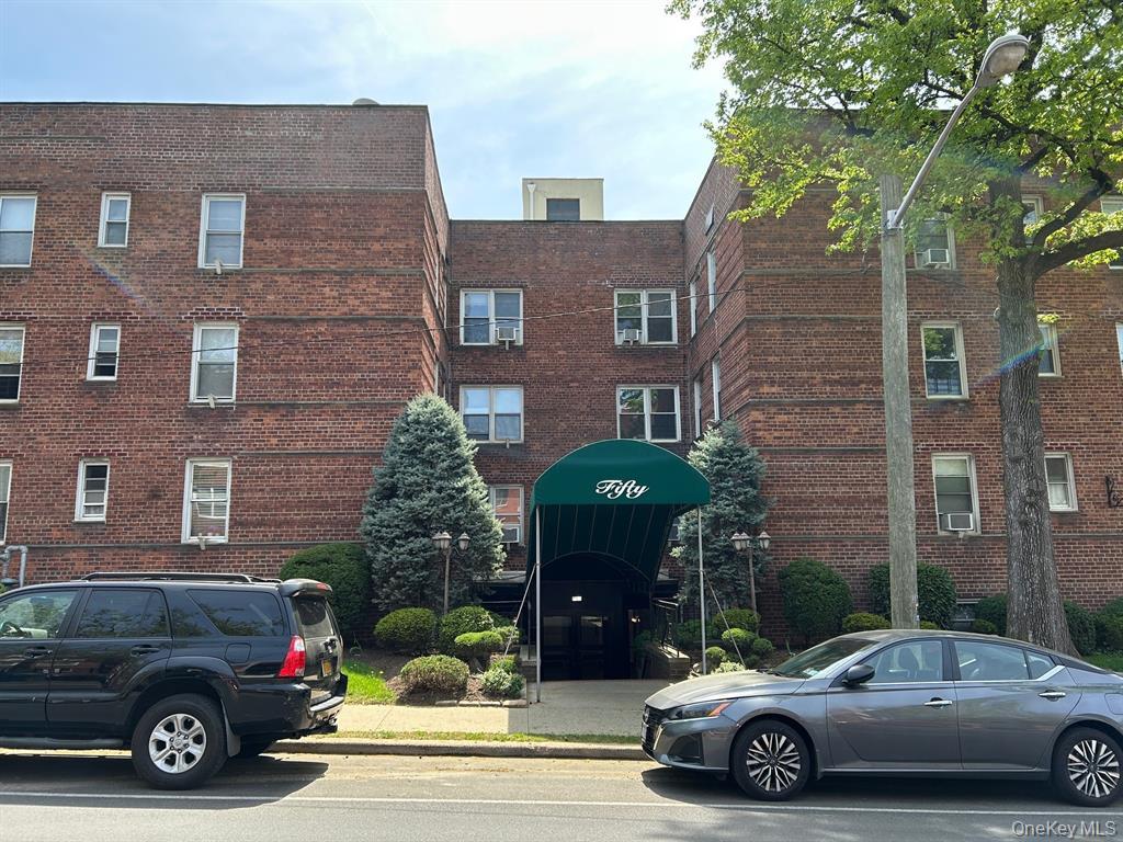 50 South Middle Neck Road, Unit 1B Great Neck, NY 11021 - Photo 1 of 11 a car parked in front of a brick house