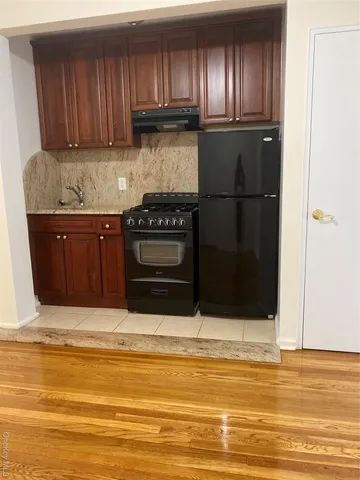 a kitchen with granite countertop stainless steel appliances and refrigerator
