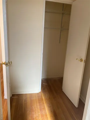 a view of hallway with wooden floor