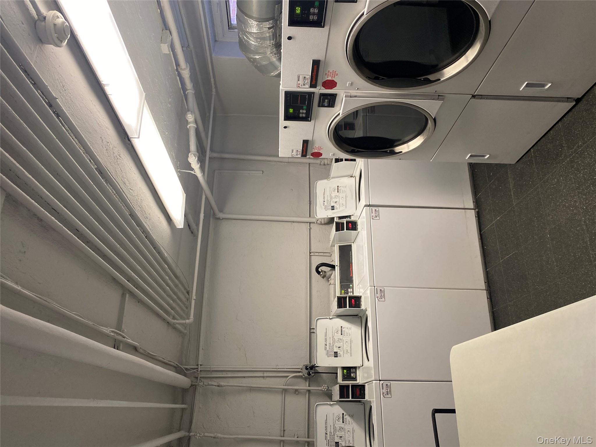 50 South Middle Neck Road, Unit 1B Great Neck, NY 11021 - Photo 10 of 11 a utility room with dryer and washer