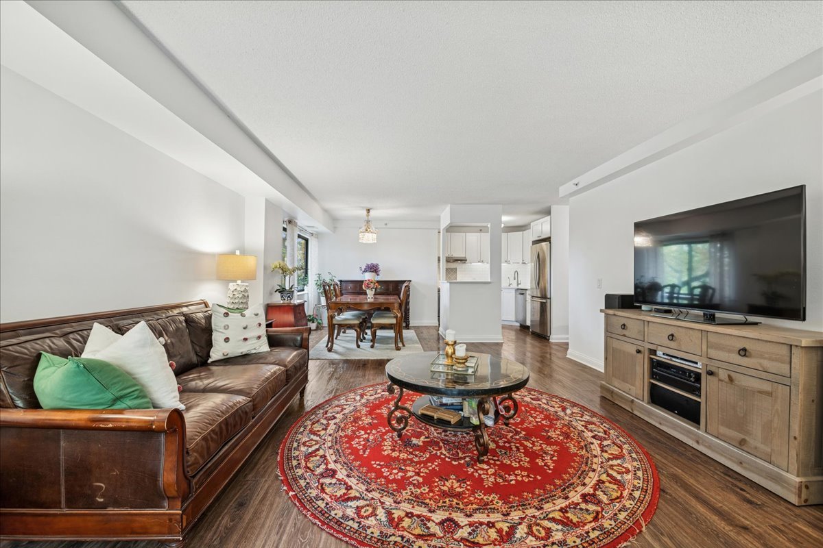 1800 Huntington Boulevard, Unit 212 Hoffman Estates, IL 60169 - Photo 4 of 15 a living room with furniture and a flat screen tv