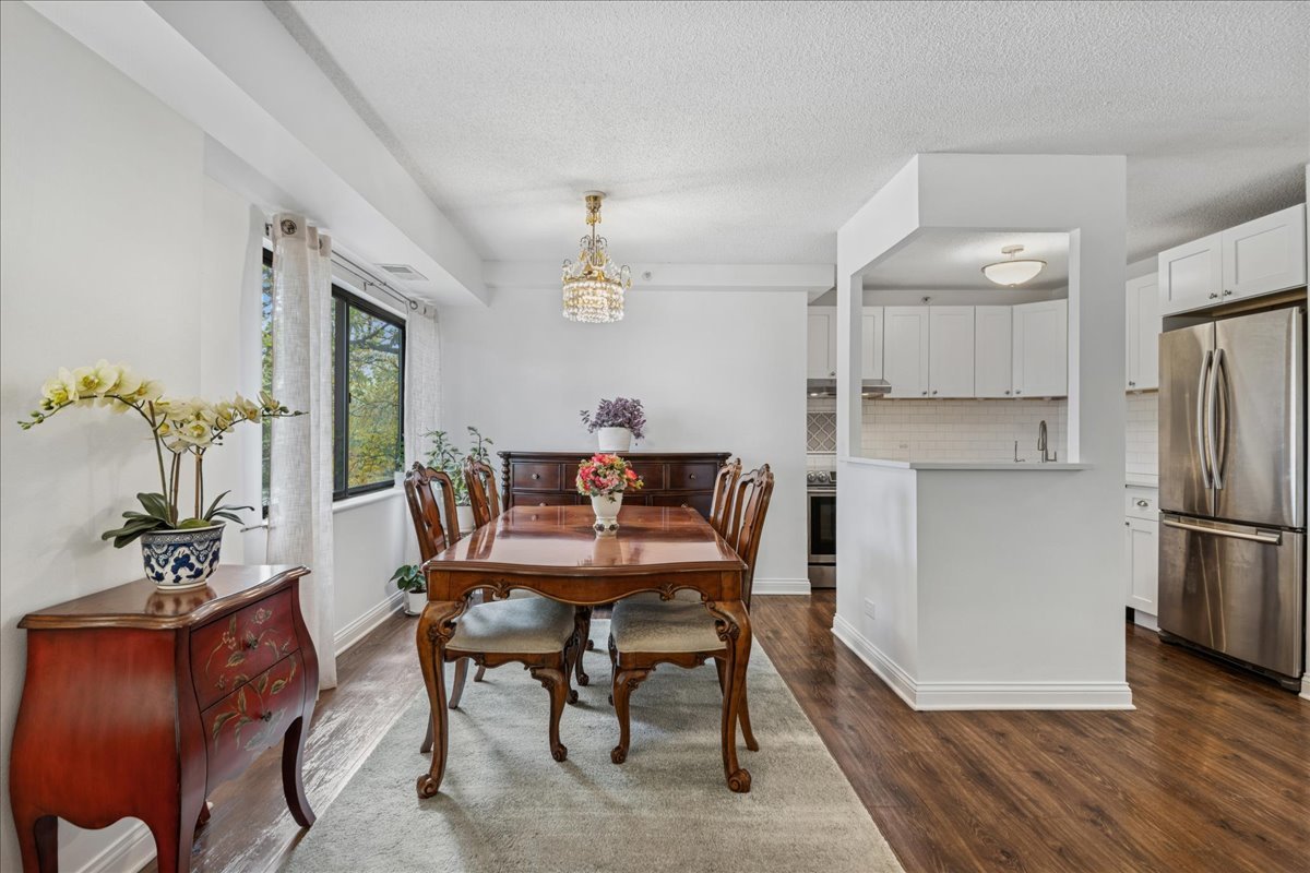 1800 Huntington Boulevard, Unit 212 Hoffman Estates, IL 60169 - Photo 6 of 15 a dining room with furniture and wooden floor