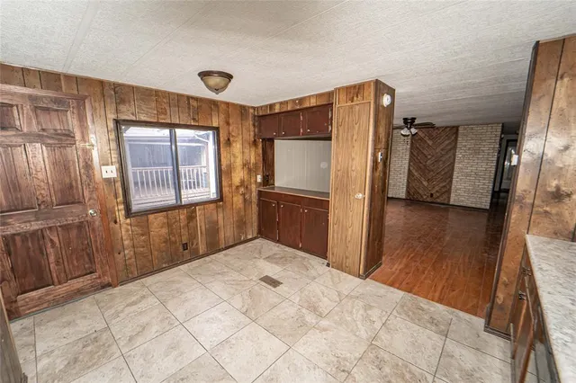 a bedroom with a bed and a refrigerator