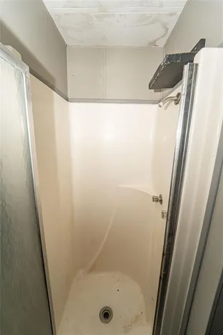 a bathroom with a glass shower door and a sink