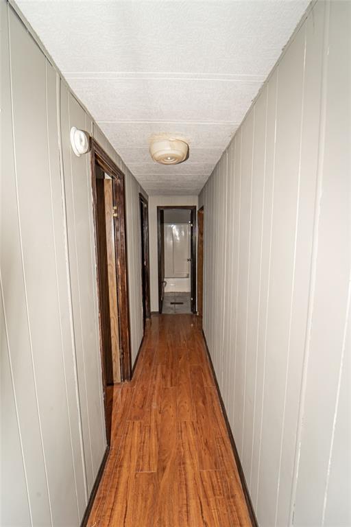 122 County Road 306 Breckenridge, TX 76424 - Photo 18 of 40 a view of a hallway with wooden floor and staircase