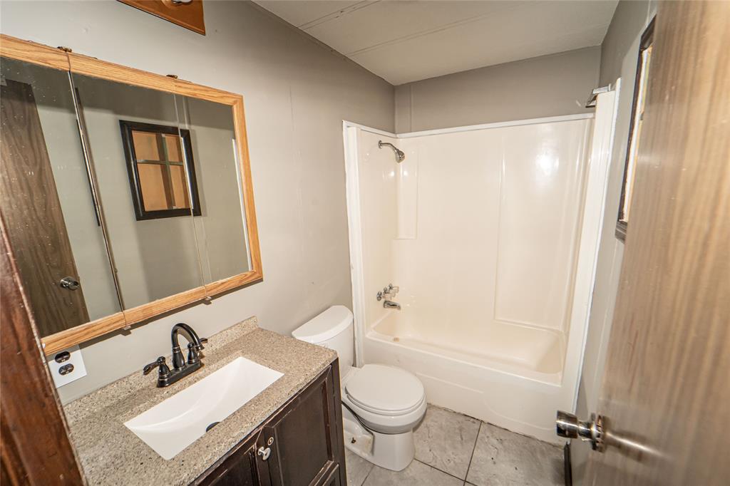 122 County Road 306 Breckenridge, TX 76424 - Photo 23 of 40 a bathroom with a sink toilet and shower