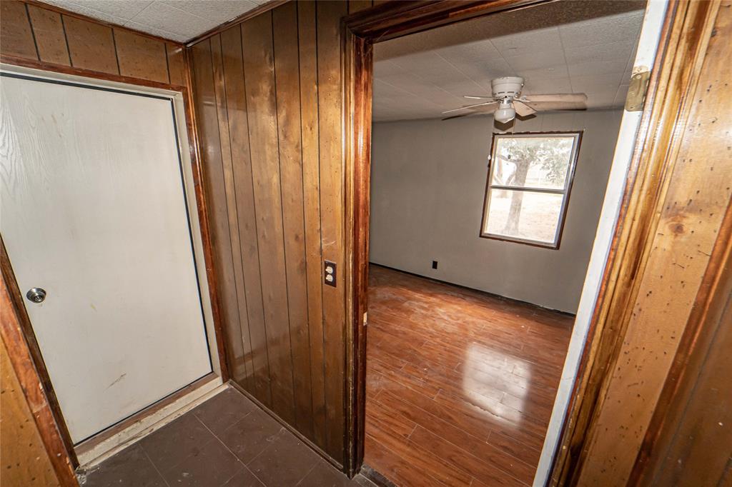 122 County Road 306 Breckenridge, TX 76424 - Photo 24 of 40 a view of an empty room with wooden floor and a window
