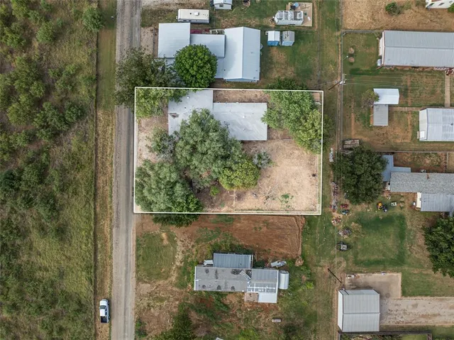 aerial view of a house with a yard