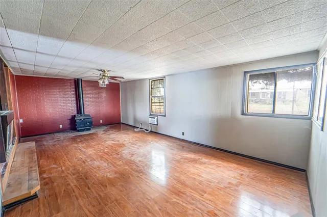 a view of a livingroom with wooden floor and window