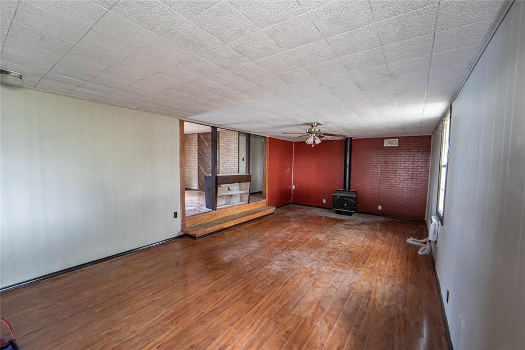122 County Road 306 Breckenridge, TX 76424 - Photo 9 of 40 a view of empty room with wooden floor and fan