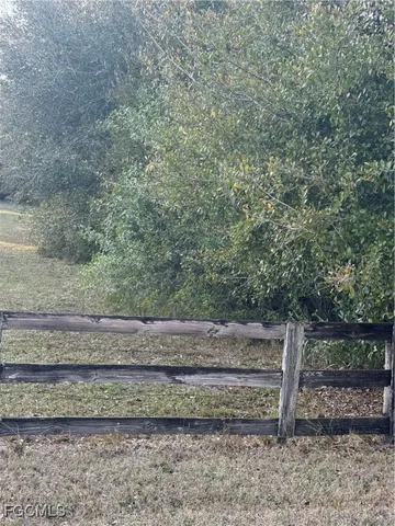 a view of backyard with wooden fence