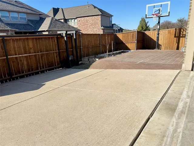 a front view of a house with garden and tree