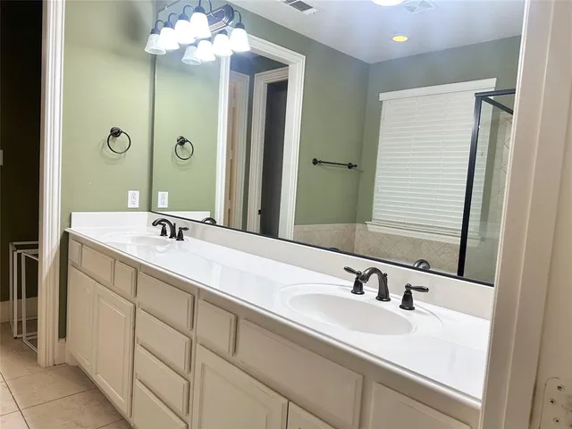 a bathroom with a sink vanity and a mirror
