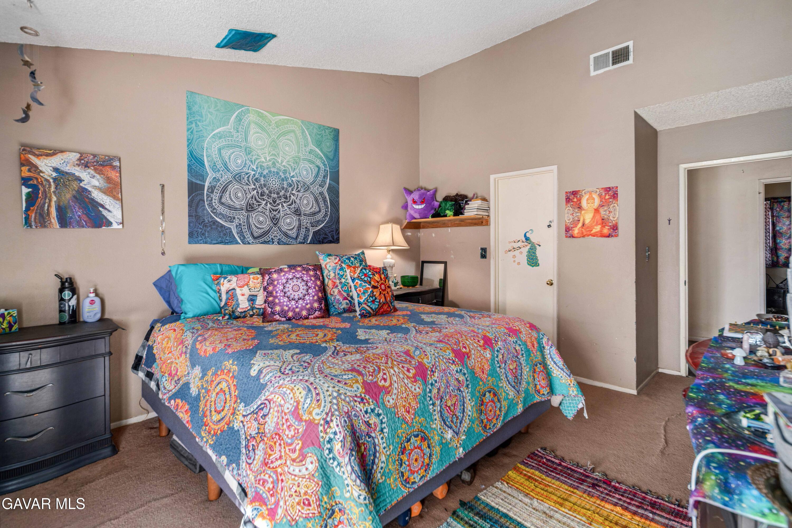 3112 Myrtle Street Rosamond, CA 93560 - Photo 15 of 49 a bedroom with a bed and wooden floor