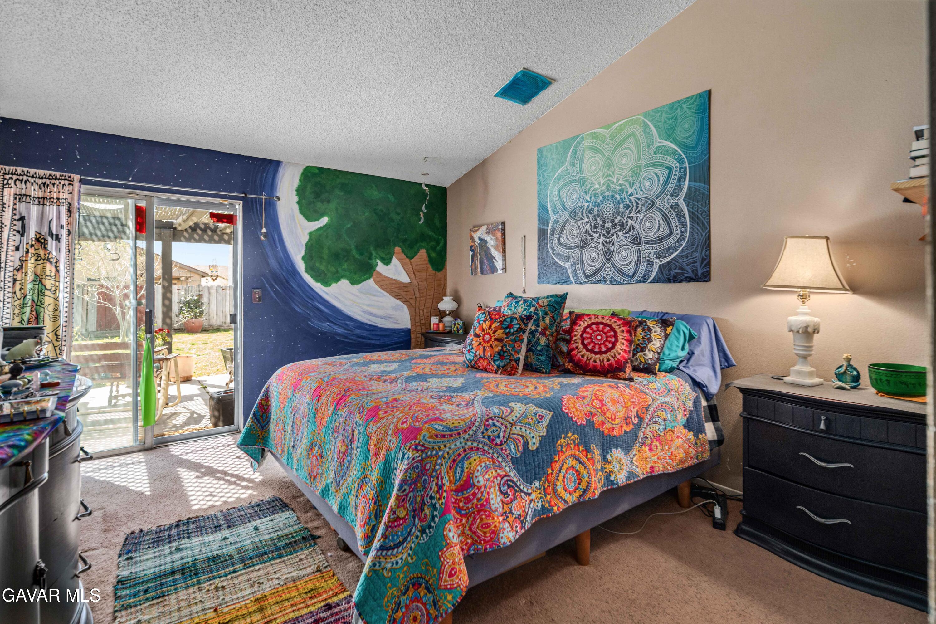 3112 Myrtle Street Rosamond, CA 93560 - Photo 16 of 49 a bedroom with a bed and large windows