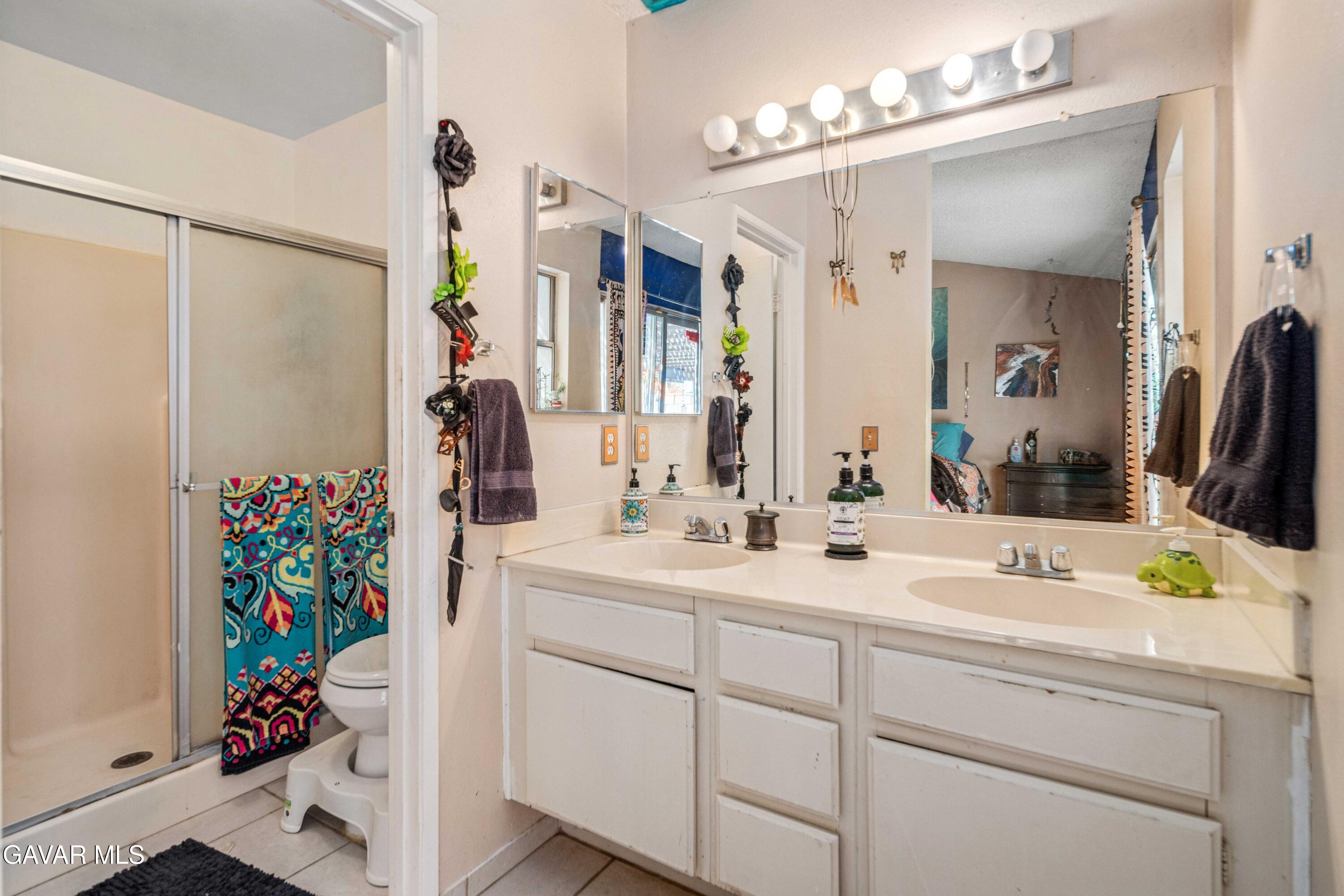 3112 Myrtle Street Rosamond, CA 93560 - Photo 20 of 49 a bathroom with a sink vanity granite and a mirror