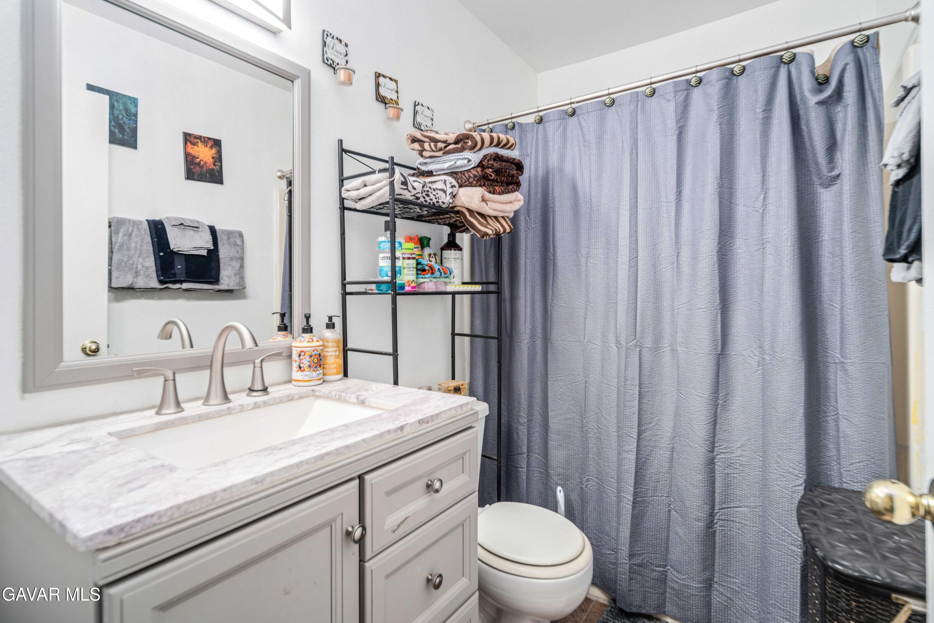 3112 Myrtle Street Rosamond, CA 93560 - Photo 21 of 49 a bathroom with a sink a toilet and shower