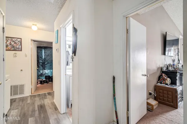 a view of a house with a yard and potted plants