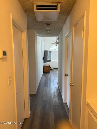 a backyard of a house with table and chairs plants