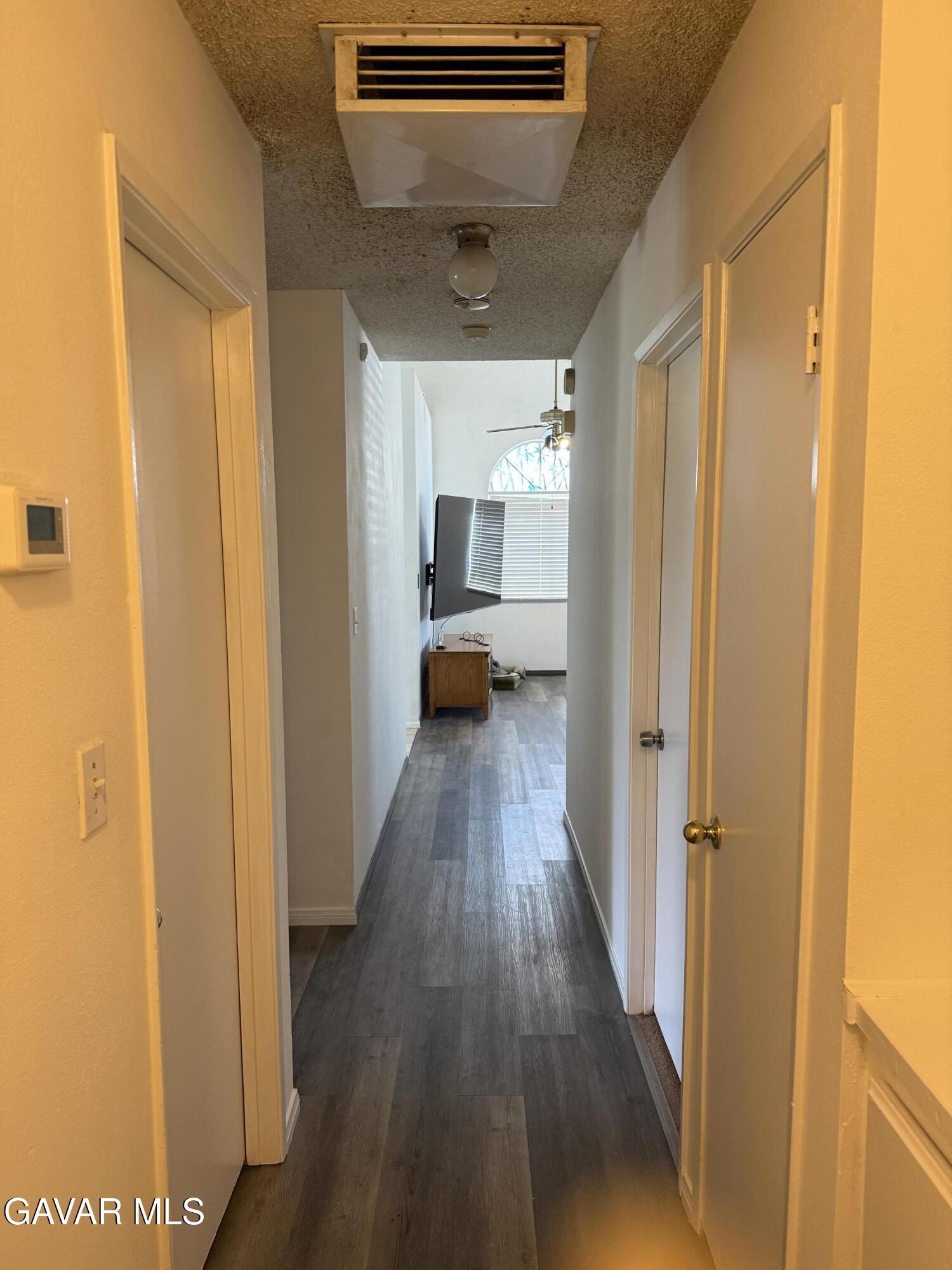 3112 Myrtle Street Rosamond, CA 93560 - Photo 24 of 49 a view of a hallway with wooden floor and closet