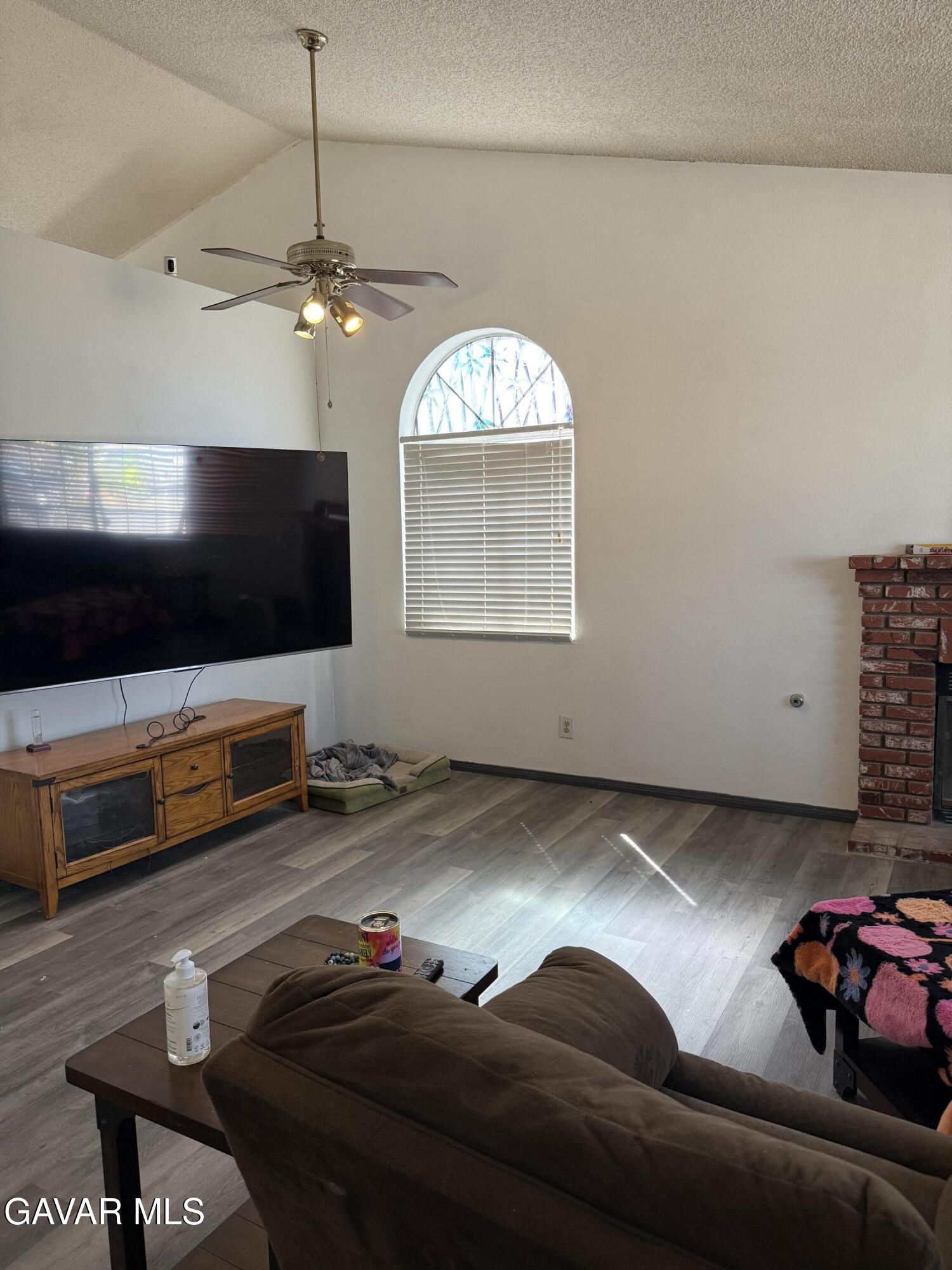 3112 Myrtle Street Rosamond, CA 93560 - Photo 27 of 49 a living room with furniture and a flat screen tv