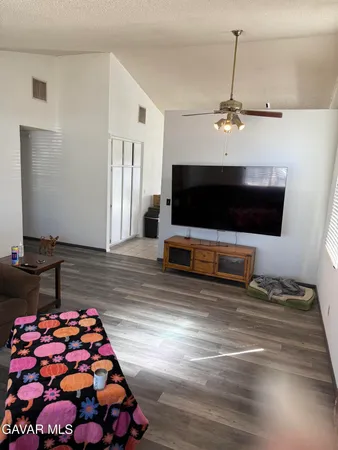 a view of a backyard with plants and a fountain