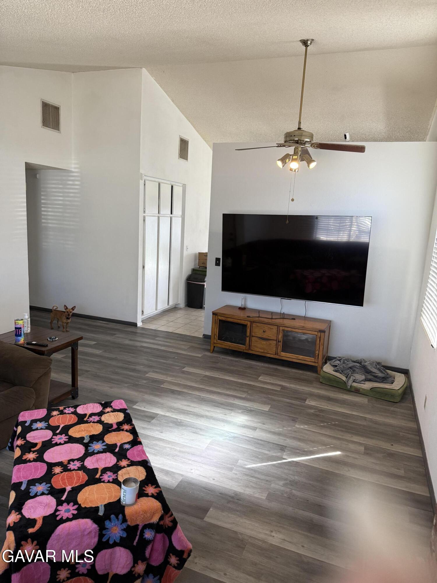 3112 Myrtle Street Rosamond, CA 93560 - Photo 28 of 49 a living room with furniture and a flat screen tv