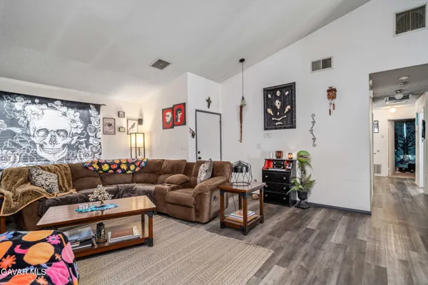 a dining room with furniture potted plants and wooden floor