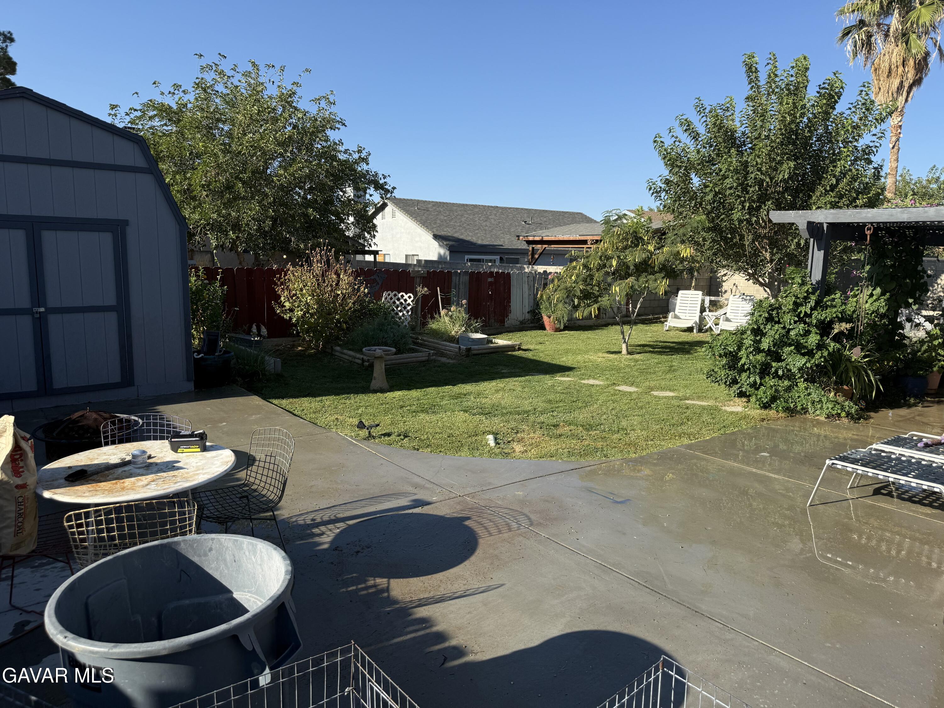 3112 Myrtle Street Rosamond, CA 93560 - Photo 41 of 49 a backyard of a house with table and chairs plants