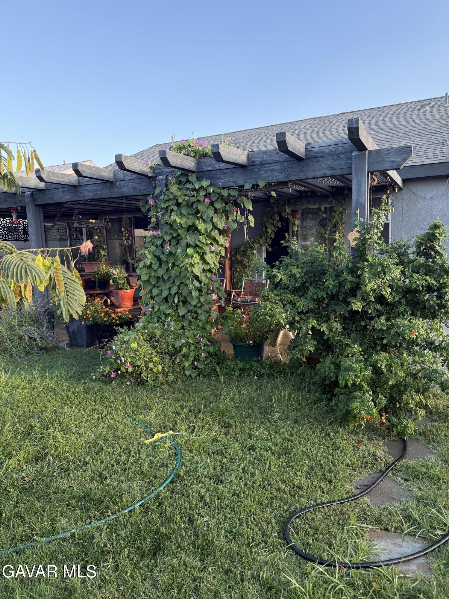 3112 Myrtle Street Rosamond, CA 93560 - Photo 47 of 49 a view of a backyard with plants and a fountain