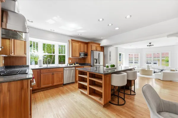 a living room with furniture large window and wooden floor
