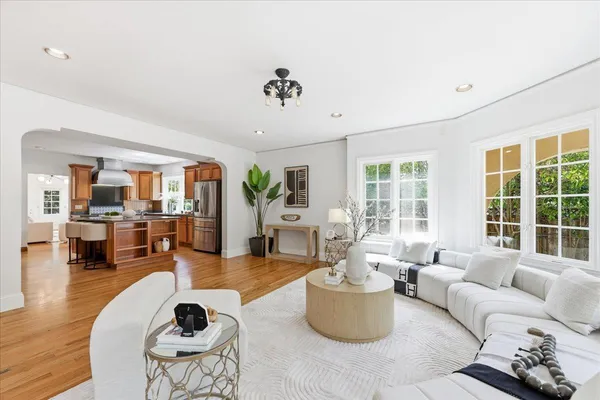 a living room with furniture and a wooden floor