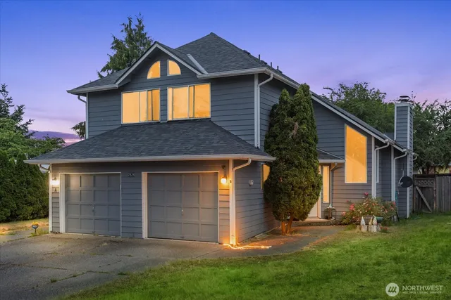 a front view of a house with a yard and garage