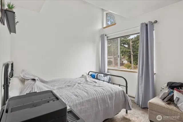 a bedroom with a bed and with windows