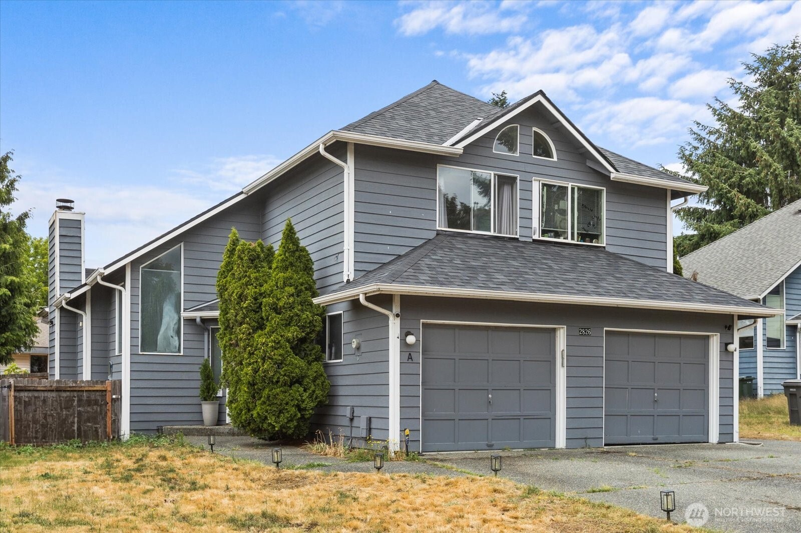 2826 Northeast 8th Street Renton, WA 98056 - Photo 3 of 20 a front view of a house with a yard