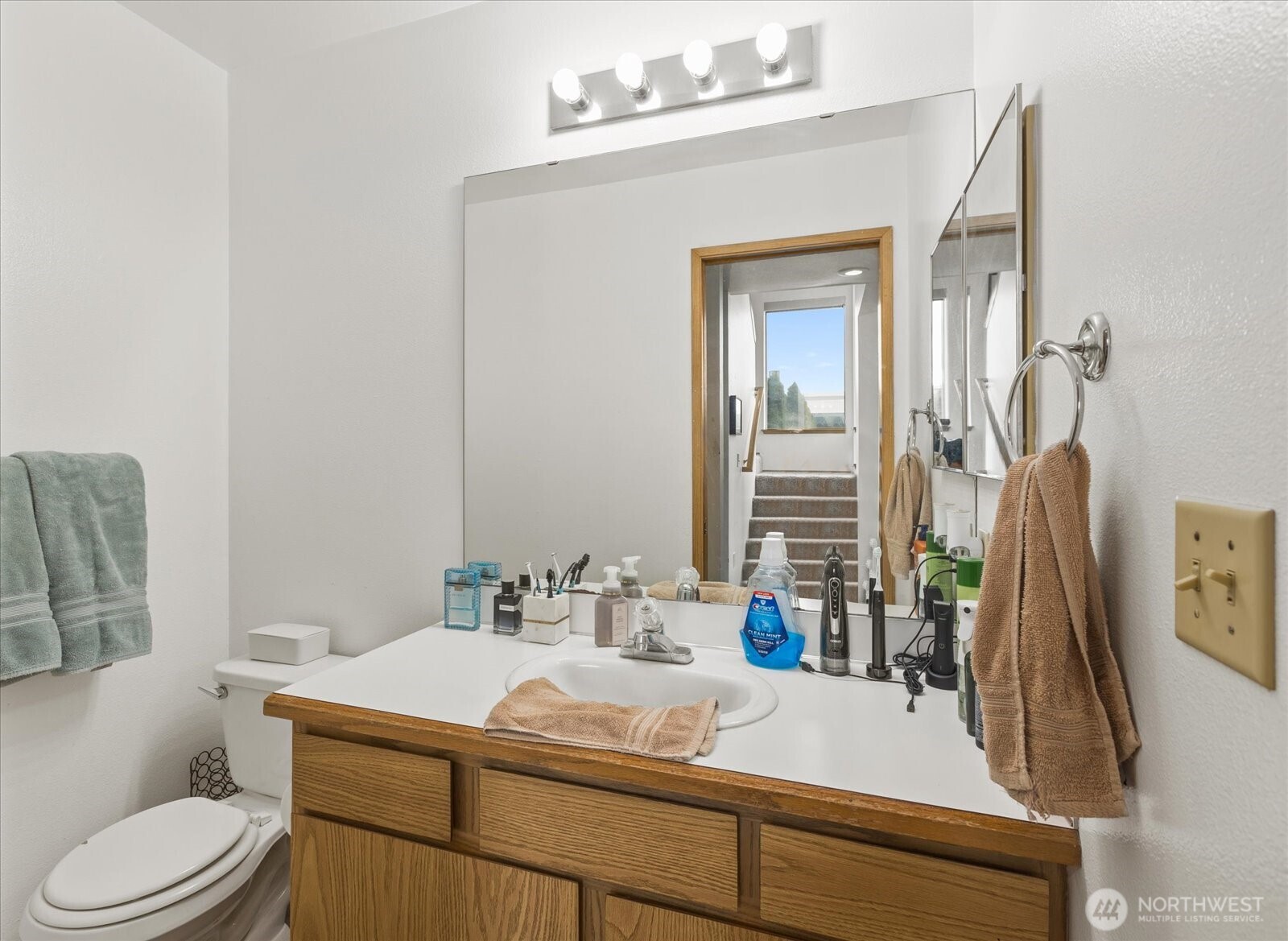 2826 Northeast 8th Street Renton, WA 98056 - Photo 10 of 20 a bathroom with a sink vanity mirror and toilet
