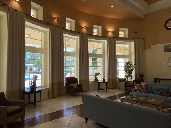 a living room with furniture and large windows
