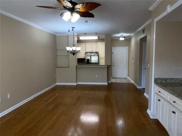 a view of a kitchen with a sink and a refrigerator