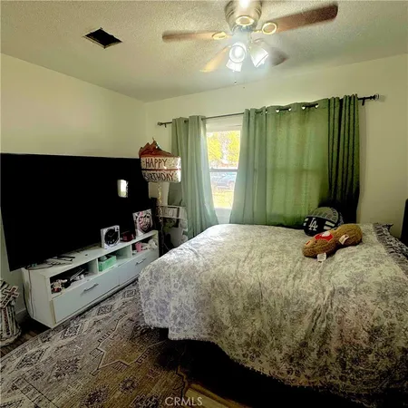 a bedroom with a bed and a couch