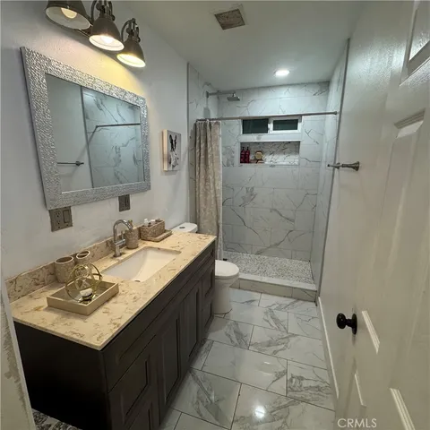 a bathroom with a sink toilet and shower