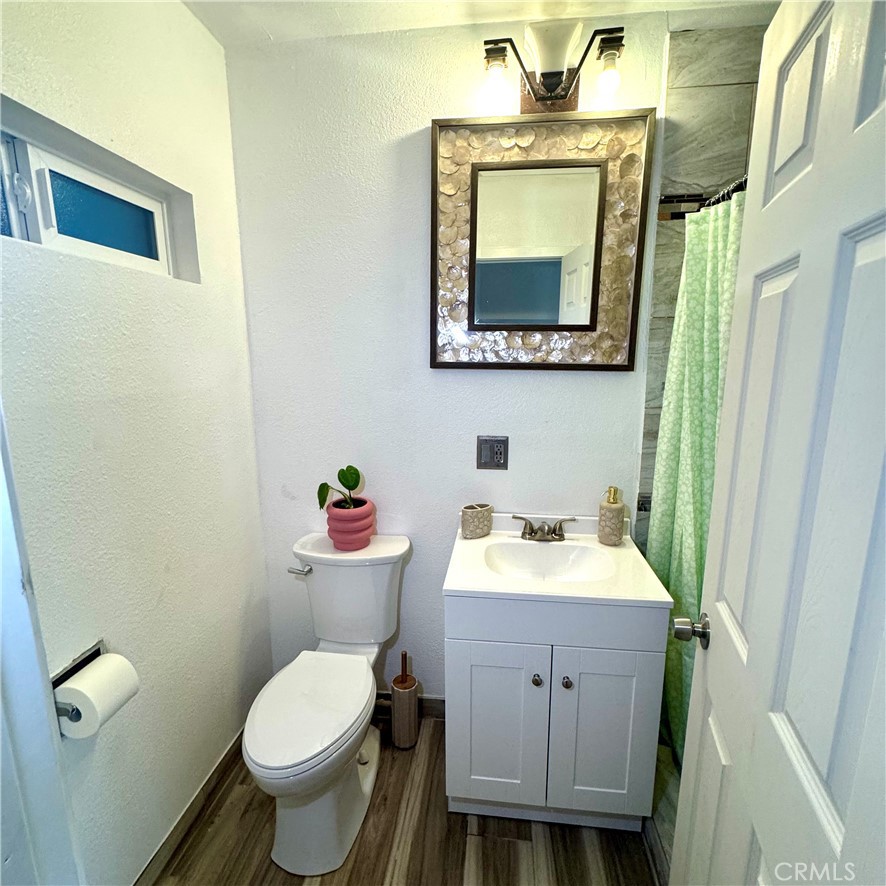 5642 Babb Avenue Riverside, CA 92503 - Photo 16 of 41 a bathroom with a toilet sink vanity and mirror