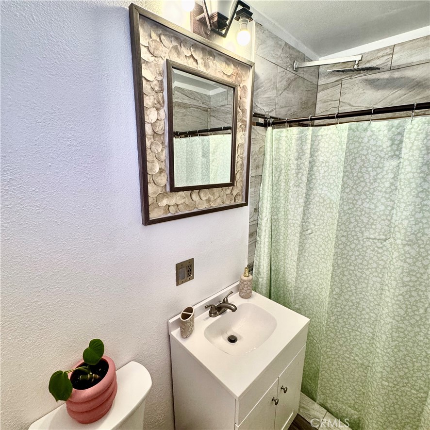 5642 Babb Avenue Riverside, CA 92503 - Photo 18 of 41 a bathroom with a sink toilet and a mirror
