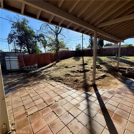 a view of backyard with wooden fence