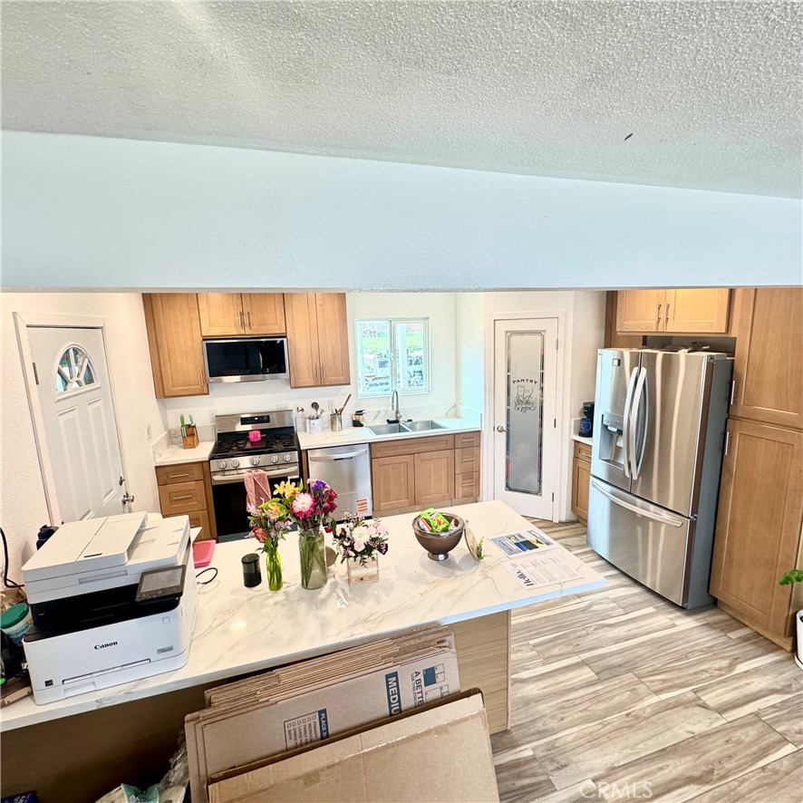 5642 Babb Avenue Riverside, CA 92503 - Photo 5 of 41 a kitchen with kitchen island a white counter top space and appliances