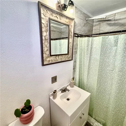 a bathroom with a sink toilet and a mirror